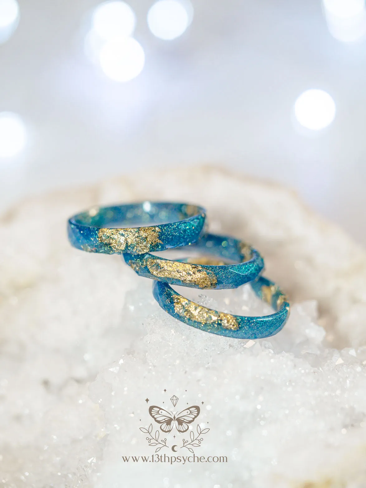 Iridescent blue faceted resin ring with gold metal flakes