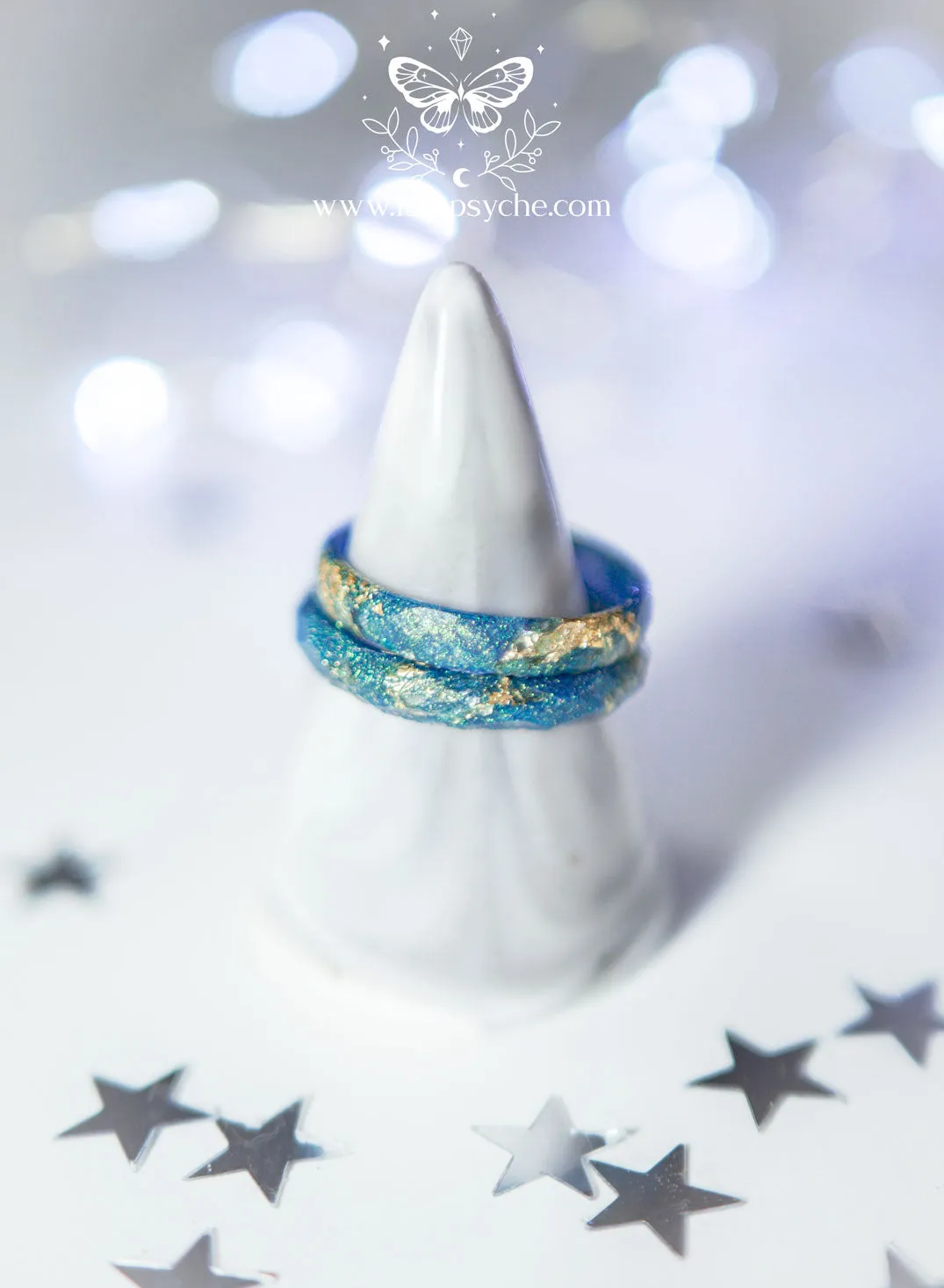 Iridescent blue faceted resin ring with gold metal flakes